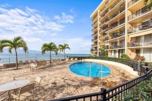 a resort with a swimming pool next to the beach at Hololani B603- Beautiful ocean views at this 2 bedroom condo in Kahana