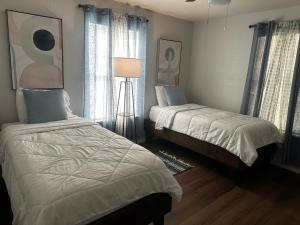 a bedroom with two beds and a lamp at Eagle Stay 5 in Eagle Pass