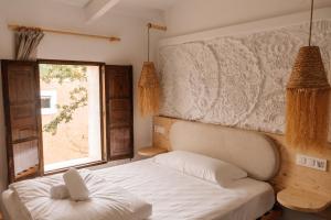 a bedroom with a white bed and a window at Claudia by Nura in Campos +104 photos