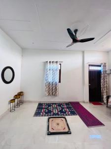 a room with a rug on the floor and a ceiling at Nirmal sadan Homestay in Kāman