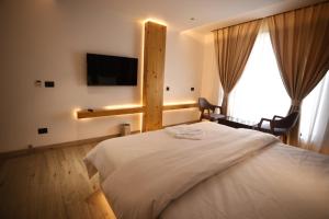 Postel nebo postele na pokoji v ubytování Grace Inn Hotel Dehradun