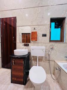 a bathroom with a toilet and a sink at Nirmal sadan Homestay in Kāman