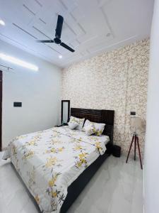 a bedroom with a bed and a ceiling fan at Nirmal sadan Homestay in Kāman