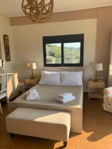 a bedroom with a large bed with two towels on it at Villa Katerina in Kalívia Thorikoú