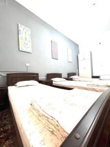 a row of beds in a room at Hello Hostel in Samarkand