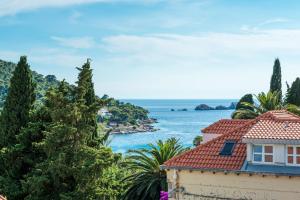 a house with a view of the ocean at Apartment Sandra FREE PRIVATE PARKING in Dubrovnik