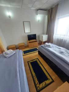 Postel nebo postele na pokoji v ubytování Magnific Hotel