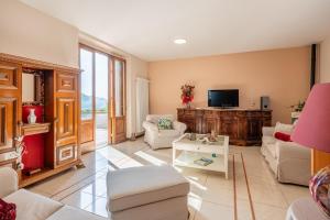 Una sala de estar con un sofá y un televisor. en Villa Adora Holiday Home, en Serravalle Pistoiese