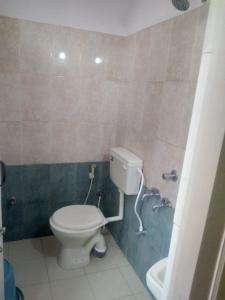 MYSORE MAHALAKSHMI ROOMS في ميسور: حمام مع مرحاض وحوض استحمام