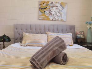 a bed with a blanket and pillows on it at Mt Eden Tidy Unit A in Auckland