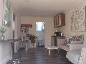 a living room with a couch and a table at Mt Eden Tidy Unit A in Auckland