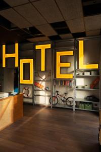 a room with yellow lights and bikes on the wall at Re Versiliana Hotel in Marina di Pietrasanta
