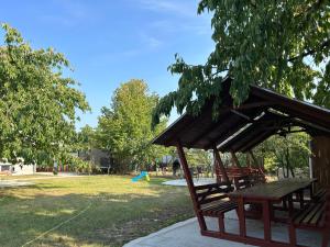 a picnic shelter in a park with a kite at Pensiunea Cornelius in Piatra Neamţ