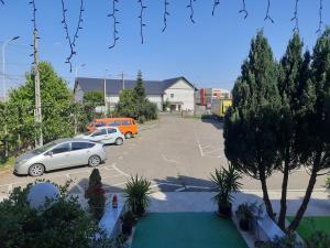 a parking lot with two cars parked in it at Pensiunea Cornelius in Piatra Neamţ