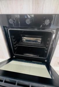 an oven with the door open in a kitchen at The Abode in Gaborone