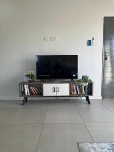 a flat screen tv sitting on top of a entertainment center at The Abode in Gaborone