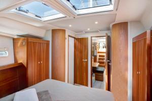 a bedroom with a bed and a skylight at Sailboat Hanse 455 in Positano