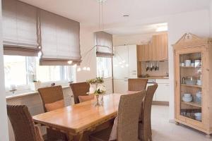 a kitchen with a wooden table and chairs at Harzhaus Romantica in Hahnenklee-Bockswiese