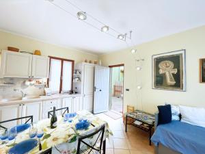 a kitchen and living room with a table and a couch at Bagnaia Lido 16 - ArgonautiVacanze in Portoferraio +22 photos