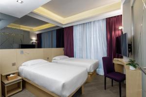 Krevet ili kreveti u jedinici u okviru objekta Starphire Hotel