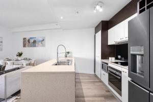 a kitchen with a sink and a counter top at Wings Apartments - QStay in Gold Coast +144 photos