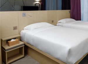 Krevet ili kreveti u jedinici u okviru objekta Starphire Hotel