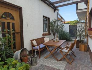 a wooden table and chairs on a patio at Ihre Ferienwohnung in 67454 Haßloch - Pfalz in Haßloch