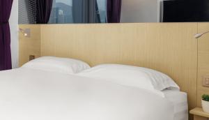 Krevet ili kreveti u jedinici u okviru objekta Starphire Hotel