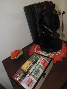 una mesa con cafetera y una caja con libros en The Attic Home Vallo della Lucania, en Vallo della Lucania