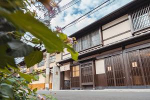 a building with wooden doors and windows on a street at 谷町君 星屋 神泉ノ宿 二条城 in Kyoto