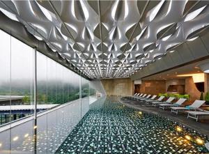 a pool in the middle of a building with chairs at Highest Floor, Skyline Studio for 4Pax In Hoverland Genting Highlands in Genting Highlands