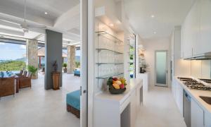 a kitchen with white countertops and a living room at Baan Kimsacheva - Seaview Private Villa in Choeng Mon Beach