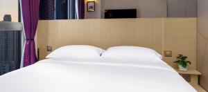 Krevet ili kreveti u jedinici u okviru objekta Starphire Hotel