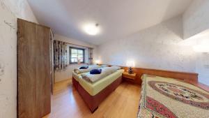 a large bedroom with a bed and a rug at Ferienwohnung Geranie in Oetz