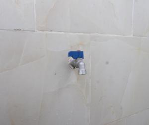 a pipe sticking out of a white wall at OYO Life 93154 White Kos Jenggala in Tanjung