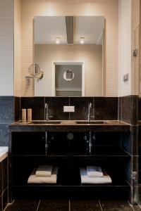 a bathroom with a sink and a mirror at Hotel Roemer Amsterdam in Amsterdam