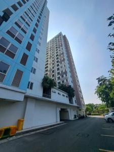 a tall building next to a parking lot at OYO Life 93140 Apartment Grand Sentraland By Fahri in Jaken 1