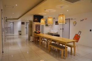 a kitchen with a long wooden table and chairs at Seoul Grand Hostel EWHA Univ in Seoul