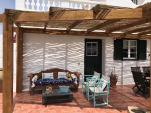 a wooden pergola with a bed on a patio at Holiday Home Finca SANT JAUME in Alaior