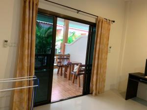 a sliding glass door leading to a patio with a table at Dow Residance in Koh Samui 