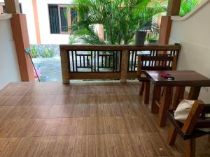 a dining room with a table and chairs and a porch at Dow Residance in Koh Samui 