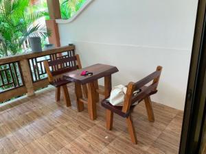 a table and two chairs in a room with a balcony at Dow Residance in Koh Samui 