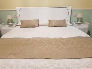 a bedroom with a large bed with two night stands at Cà del Vescovo in Imperia +26 photos