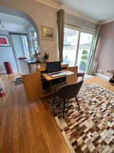 a living room with a desk with a laptop on it at Garden Place in Clevedon