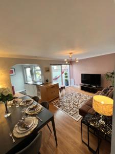 a living room with a couch and a table at Garden Place in Clevedon