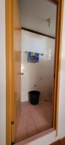 a bathroom with a shower with a black tub at La Vida Hostel in Puerto Princesa City