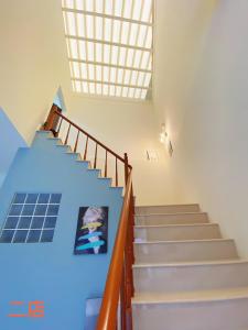 a staircase in a house with blue ceilings at Unique Homestay in Tainan