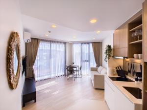a living room with a kitchen and a dining room at Skypark Laguna apartments Bangtao in Bang Tao Beach