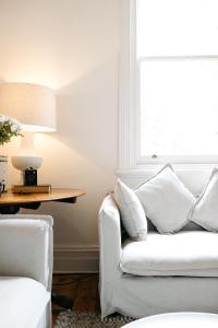 a living room with a white couch and a window at Luxurious terrace home in heart of town in Bendigo