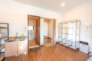 a kitchen with a sink and a shelf in a room at Los Inn Nakhon ลอส อินน์ นคร in Nakhon Phanom +70 photos